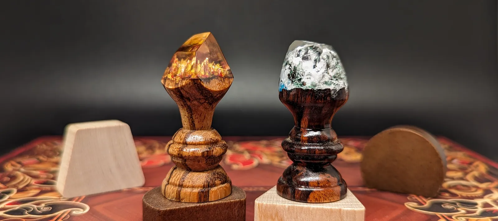 Turned hardwood capstones with resin tops beside wooden flats